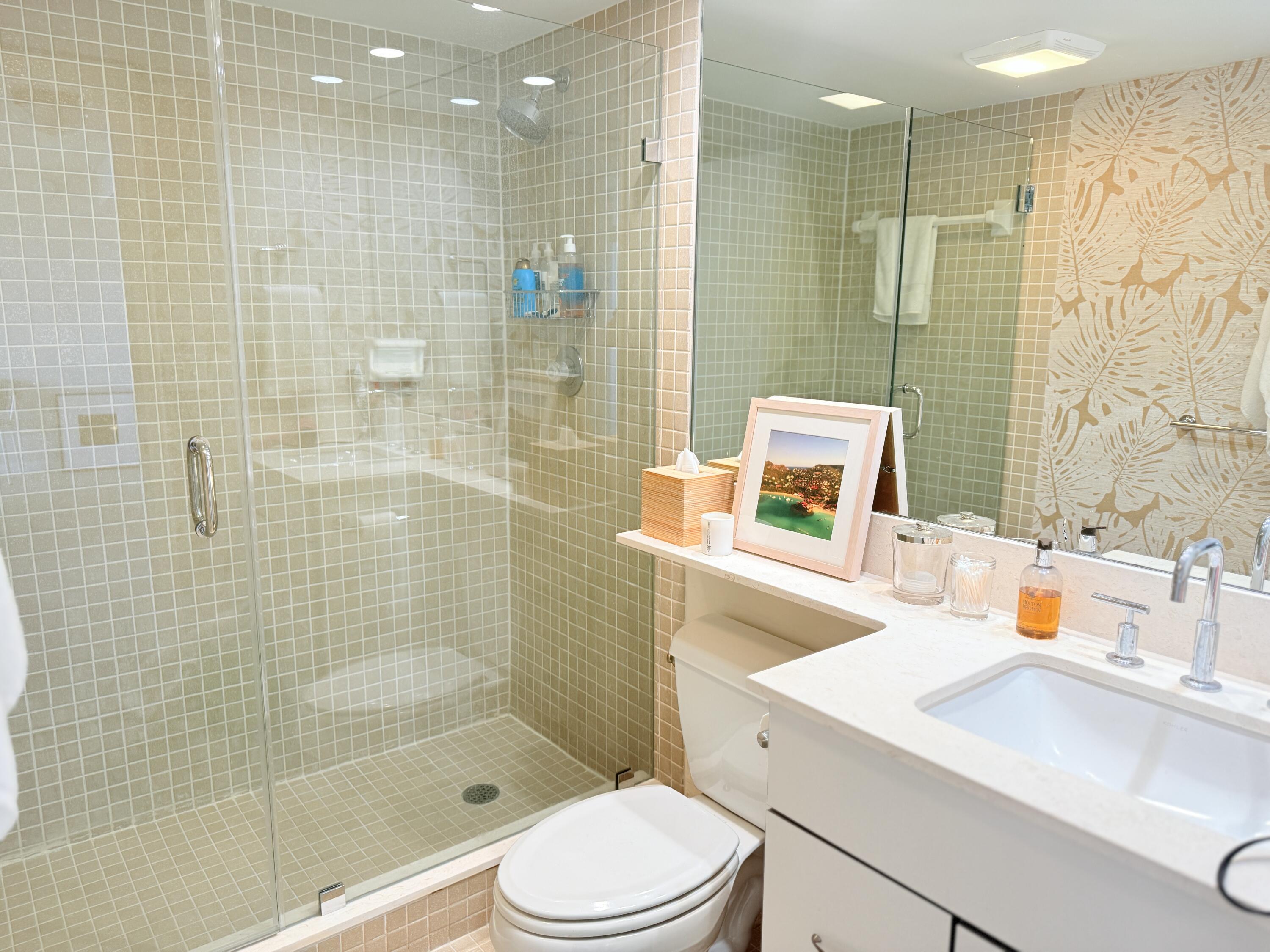 5200 North Flagler Drive, Unit 1406 West Palm Beach, FL 33407 - Photo 28 of 31 a bathroom with a sink a toilet and shower