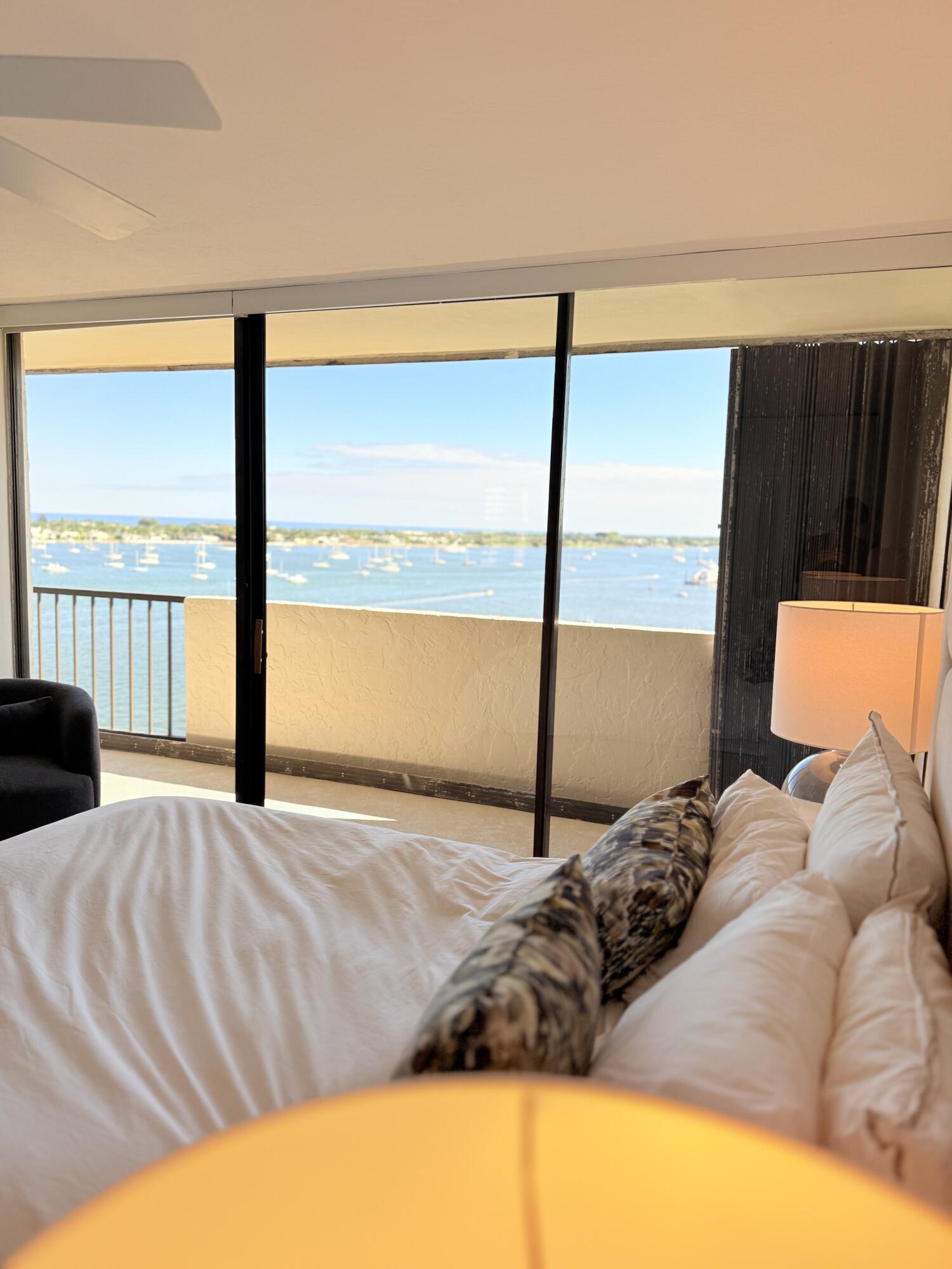 5200 North Flagler Drive, Unit 1406 West Palm Beach, FL 33407 - Photo 29 of 31 a bedroom with a bed and a large window