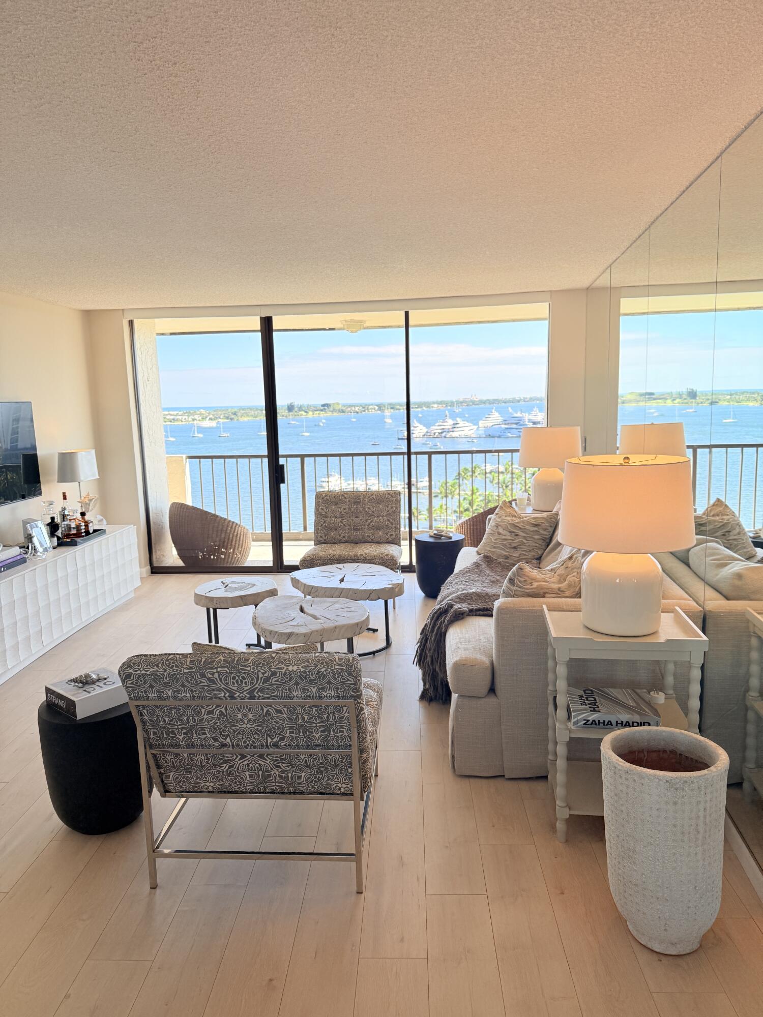 5200 North Flagler Drive, Unit 1406 West Palm Beach, FL 33407 - Photo 3 of 31 a living room with furniture and a floor to ceiling window