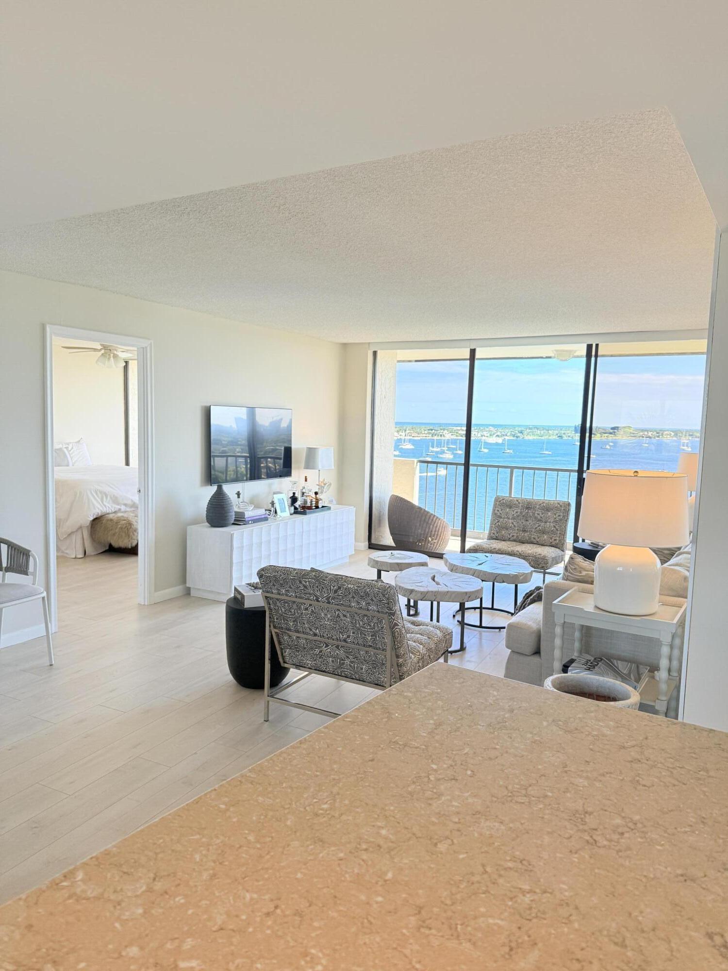 5200 North Flagler Drive, Unit 1406 West Palm Beach, FL 33407 - Photo 4 of 31 a living room with furniture and large windows