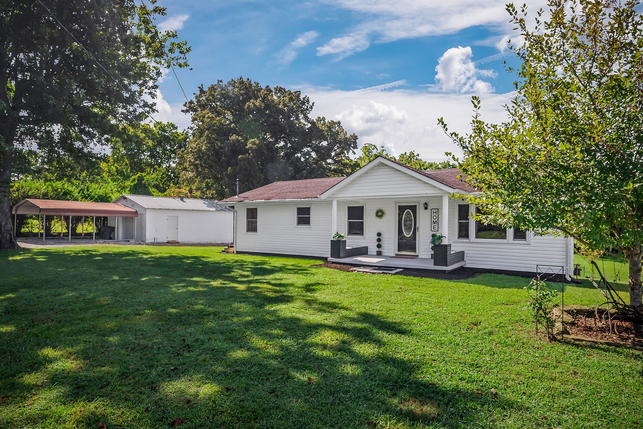 a front view of a house with garden