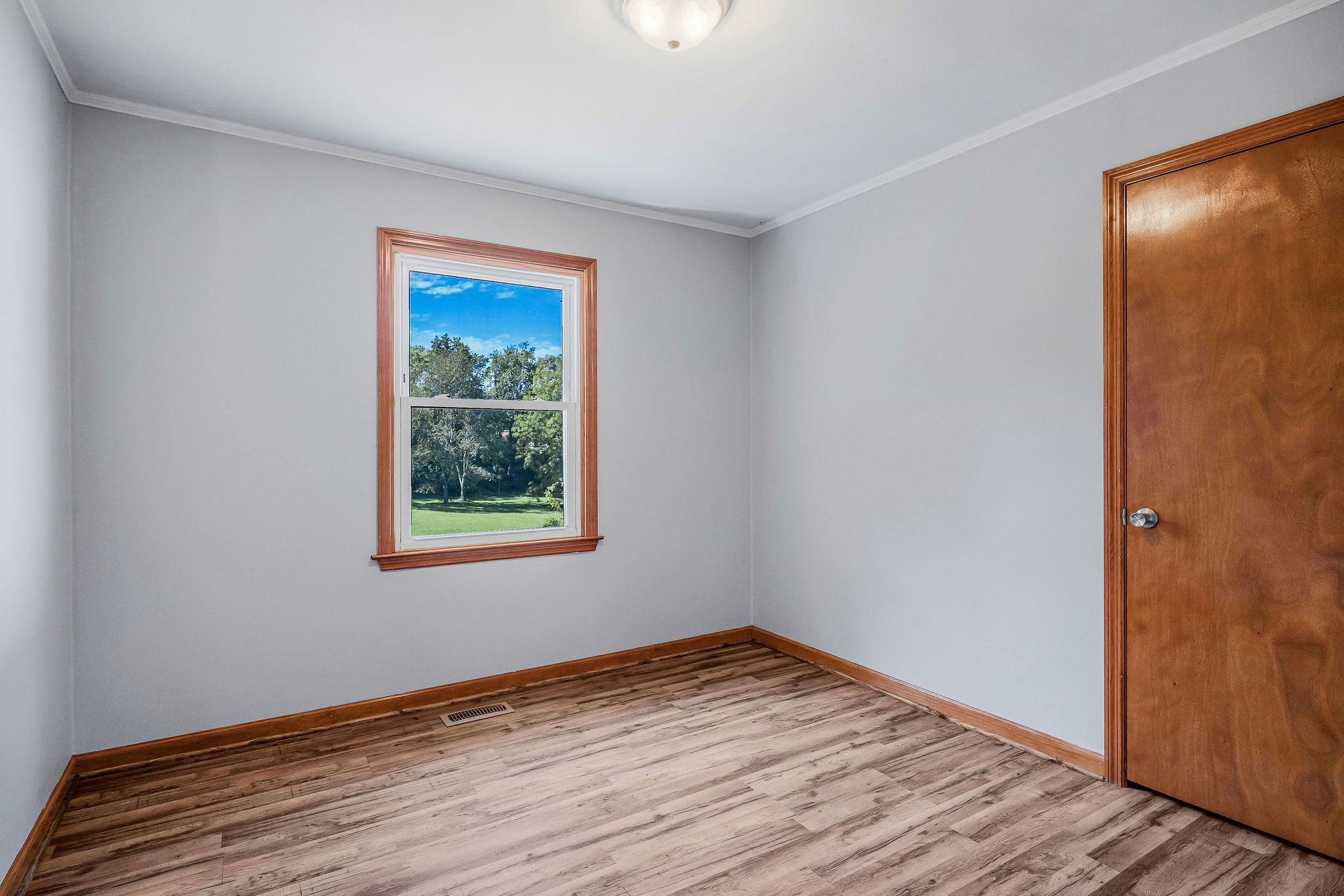 220 Higginbotham Road McMinnville, TN 37110 - Photo 7 of 21 a view of an empty room with wooden floor and a window