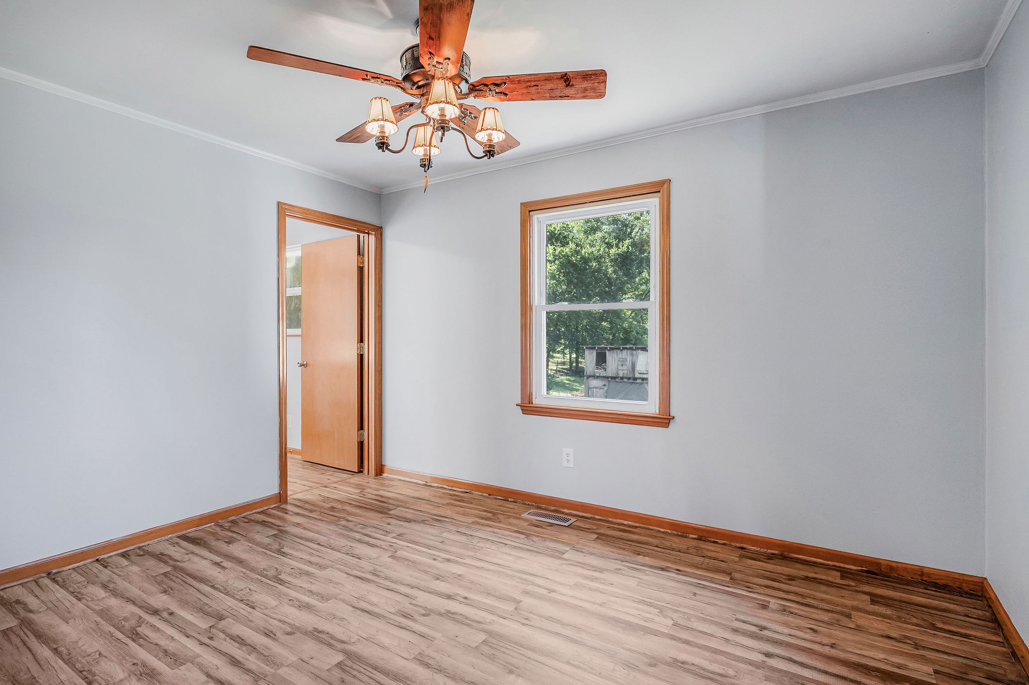 220 Higginbotham Road McMinnville, TN 37110 - Photo 8 of 21 a view of an empty room with wooden floor and a window