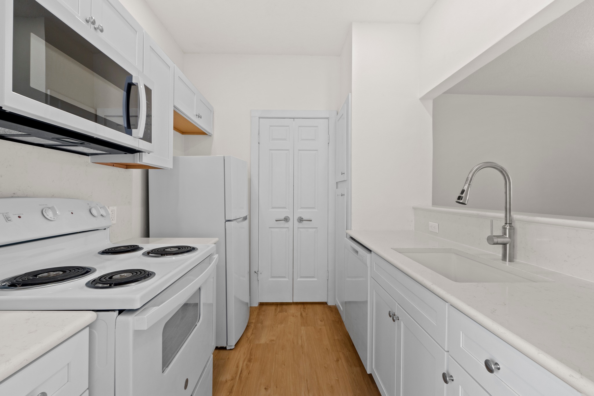 3001 Cedar Street, Unit A214 Austin, TX 78705 - Photo 11 of 23 a kitchen with a sink stove and cabinets
