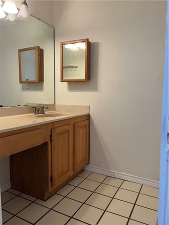 a bathroom with a double vanity sink and mirror