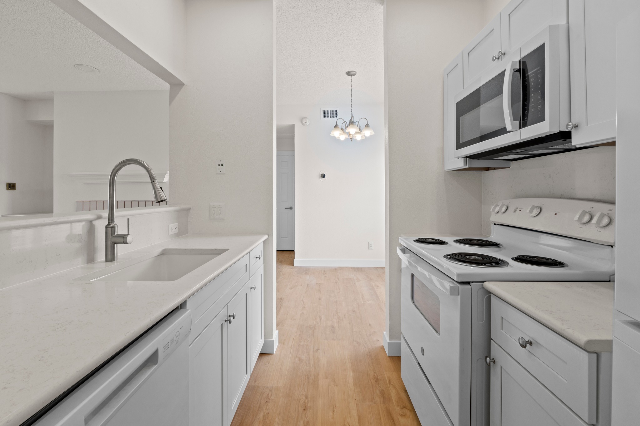 3001 Cedar Street, Unit A214 Austin, TX 78705 - Photo 13 of 23 a kitchen with stainless steel appliances granite countertop a sink stove and cabinets