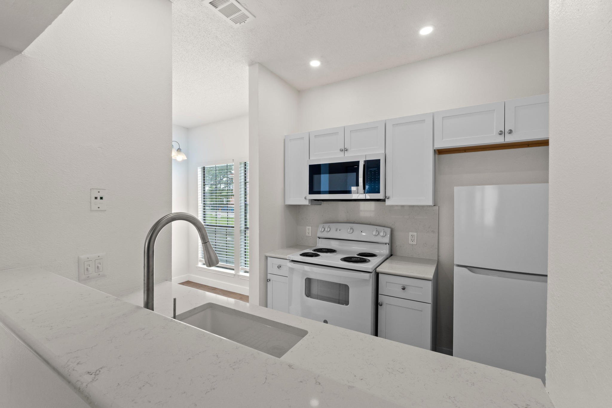 3001 Cedar Street, Unit A214 Austin, TX 78705 - Photo 14 of 23 a kitchen with stainless steel appliances granite countertop a stove a sink a refrigerator and a microwave