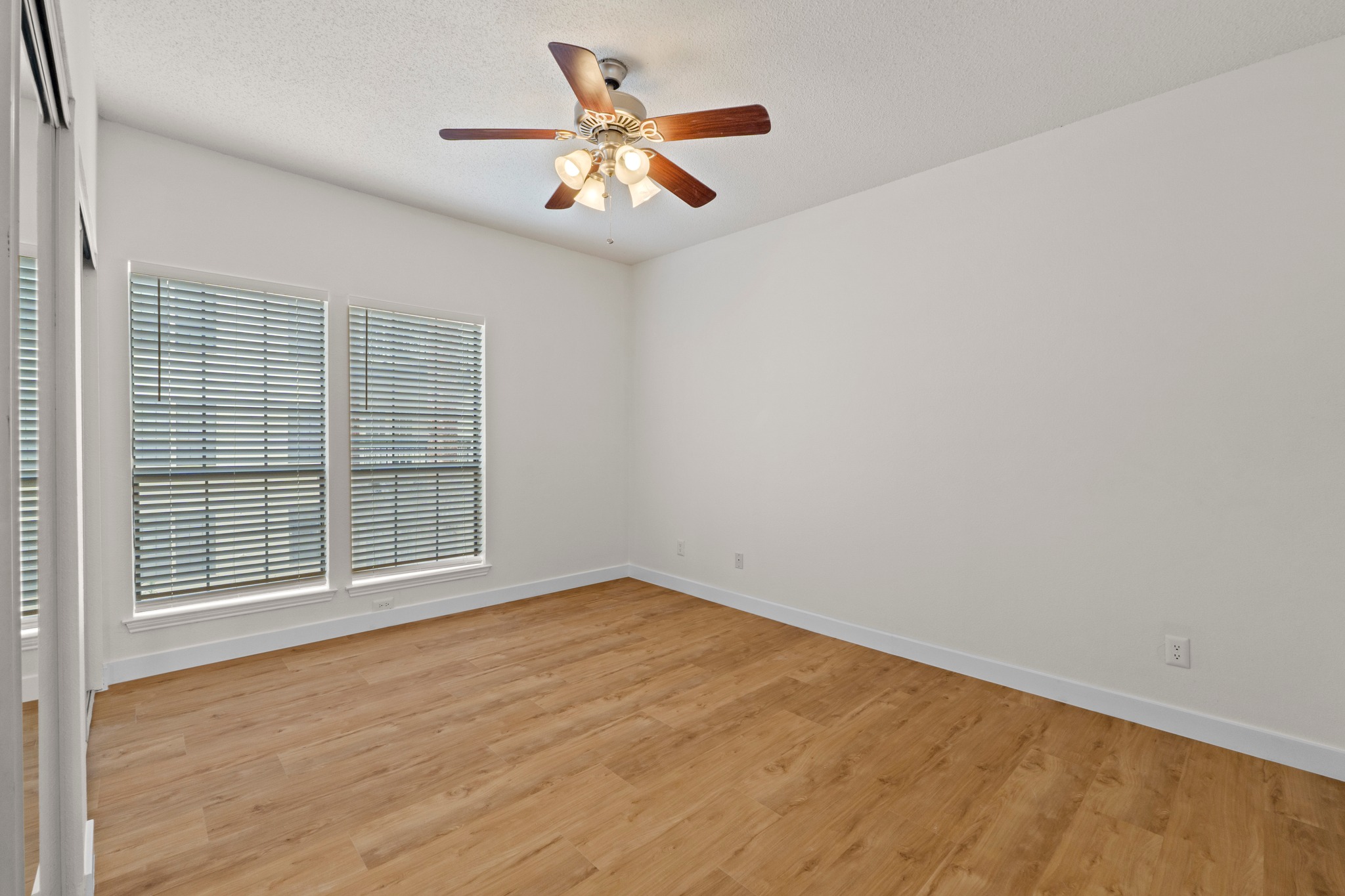 3001 Cedar Street, Unit A214 Austin, TX 78705 - Photo 15 of 23 an empty room with wooden floor and windows