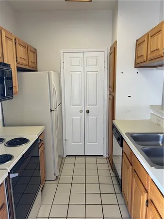a kitchen with a sink stove and refrigerator