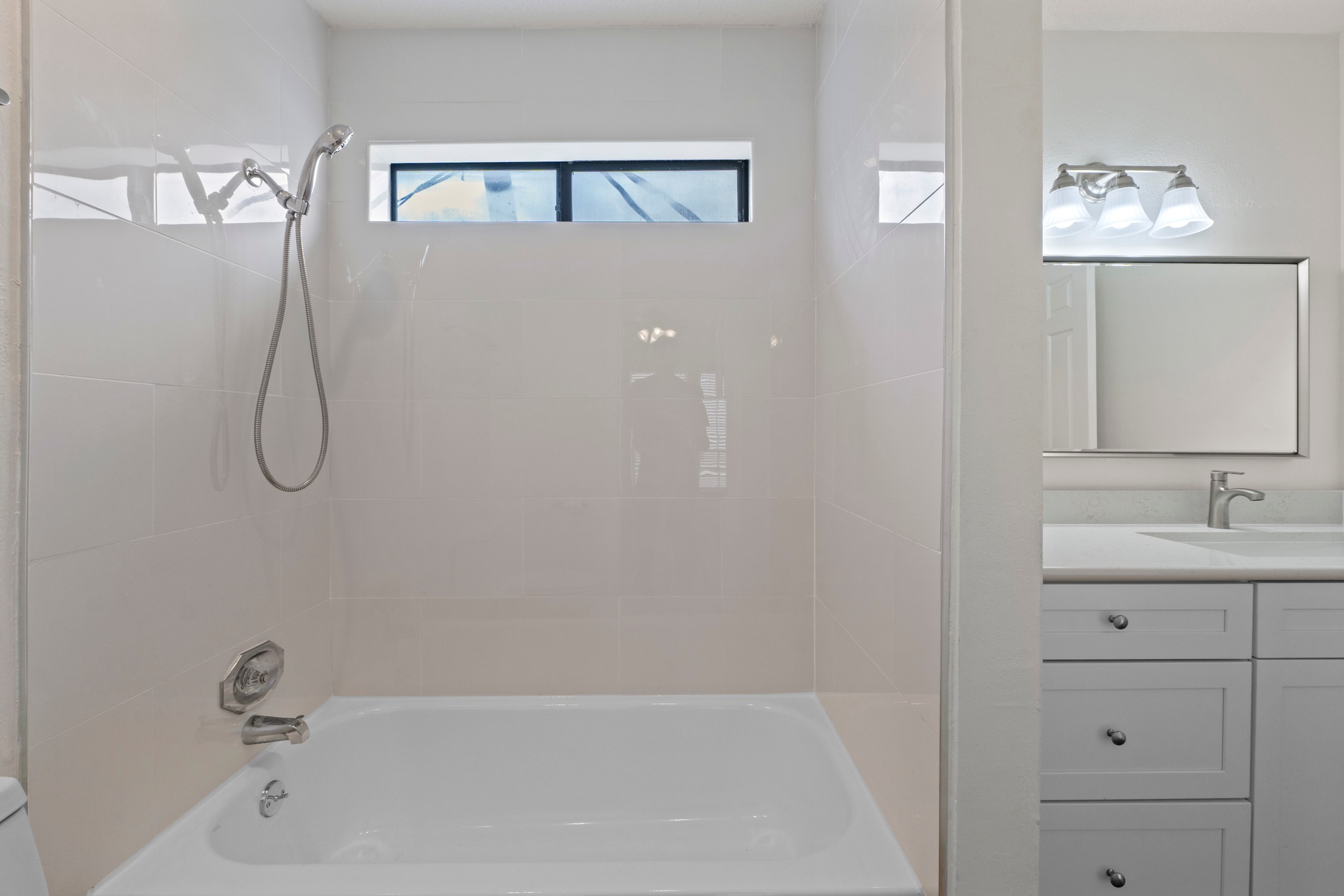 3001 Cedar Street, Unit A214 Austin, TX 78705 - Photo 18 of 23 a bathroom with a granite countertop sink a shower and a mirror