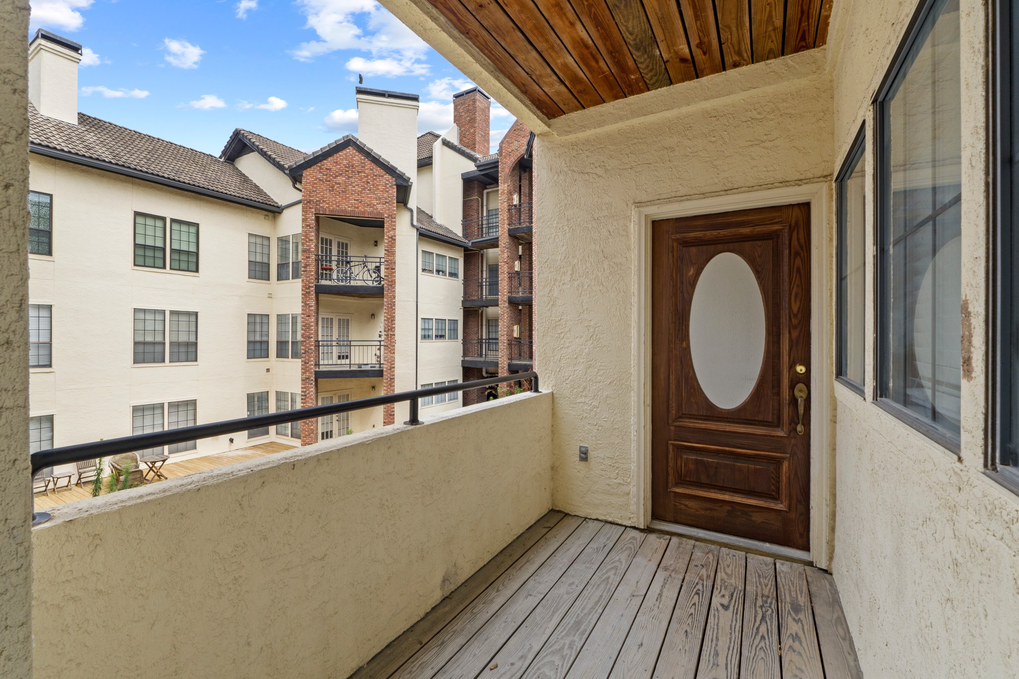 3001 Cedar Street, Unit A214 Austin, TX 78705 - Photo 3 of 23 a view of a house with a wooden deck