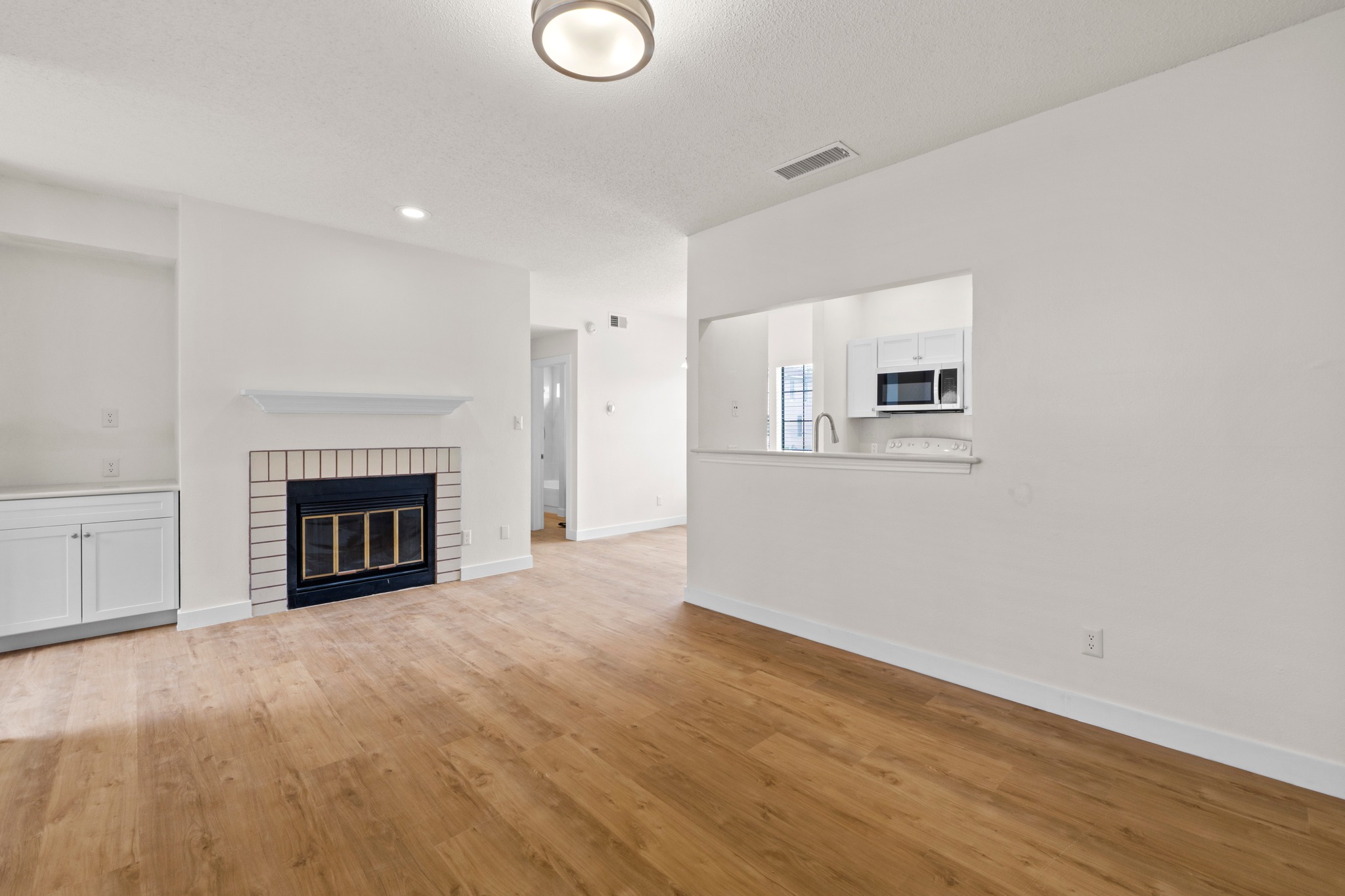 3001 Cedar Street, Unit A214 Austin, TX 78705 - Photo 5 of 23 a view of a livingroom with a fireplace and a window