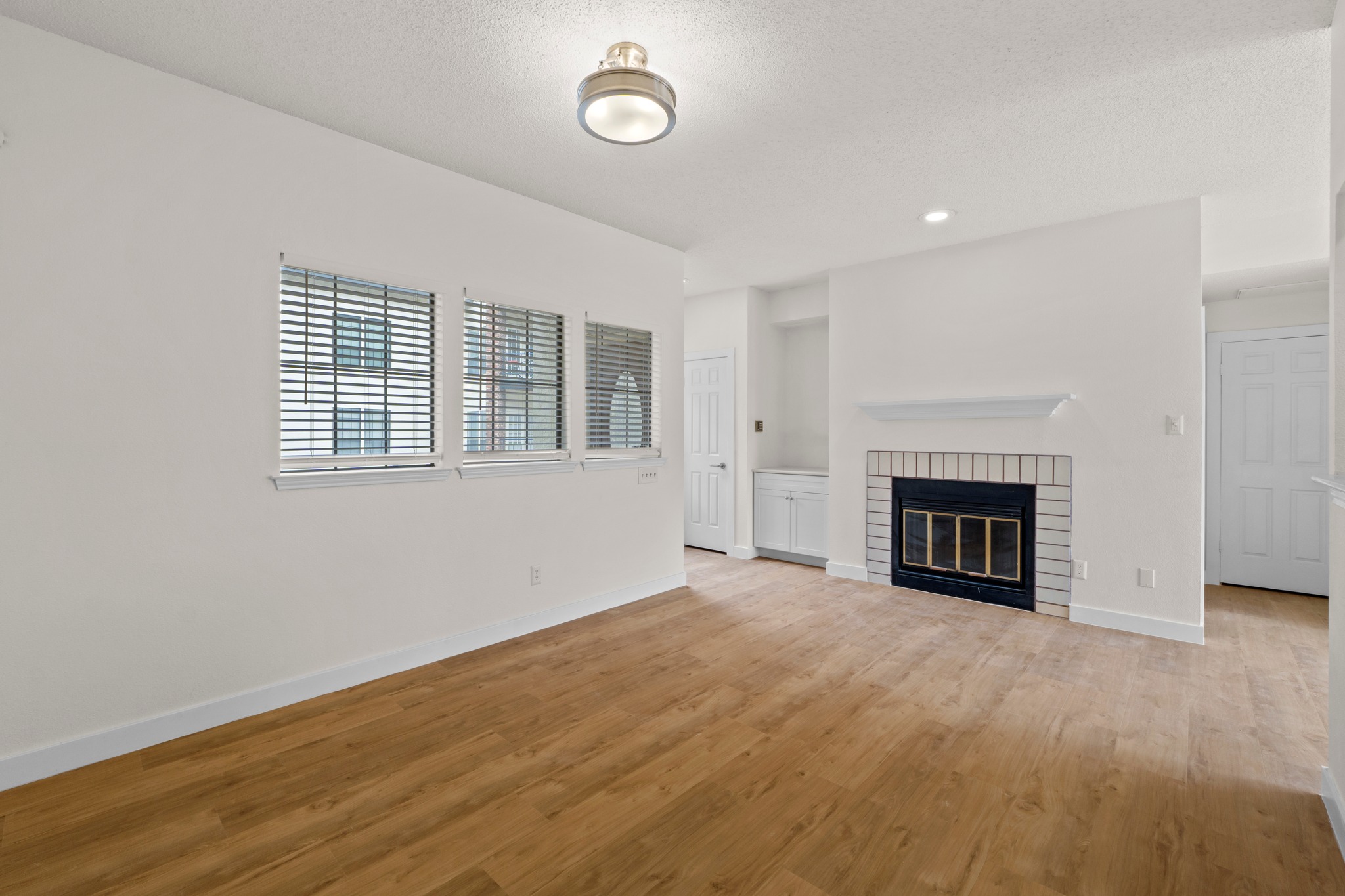 3001 Cedar Street, Unit A214 Austin, TX 78705 - Photo 6 of 23 an empty room with windows and fireplace