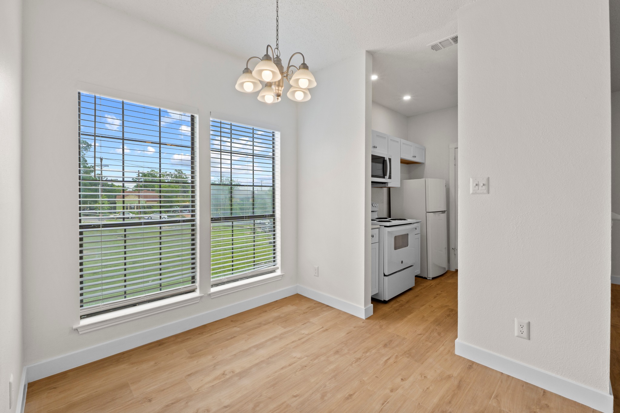 3001 Cedar Street, Unit A214 Austin, TX 78705 - Photo 9 of 23 a view of a kitchen with a dishwasher cabinets and a large window