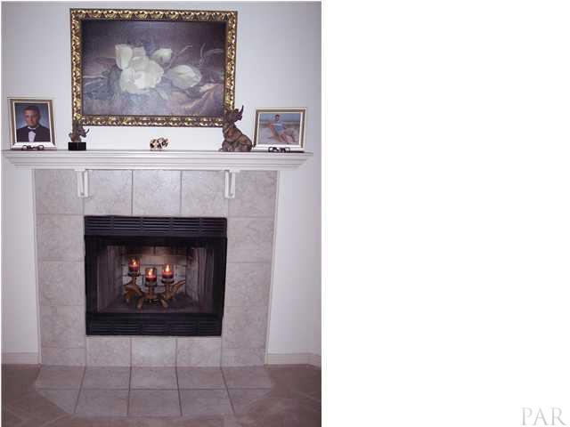 3623 Bagwell Road Pace, FL 32571 - Photo 8 of 24 Elegant tile faced wood burning fireplace with blower will keep the family warm.