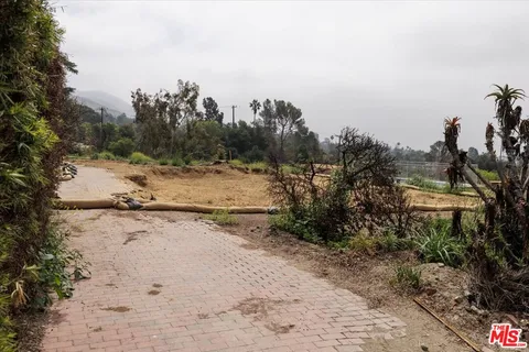 a view of dirt yard with mountain view