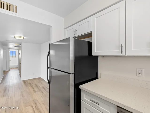 a kitchen with a refrigerator and a sink