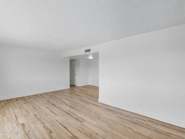 a view of an empty room and wooden floor