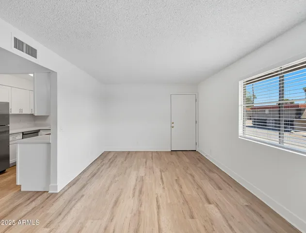 a view of a kitchen with wooden floor and a sink
