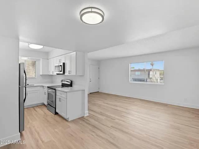 a kitchen with stainless steel appliances a stove top oven sink and cabinets