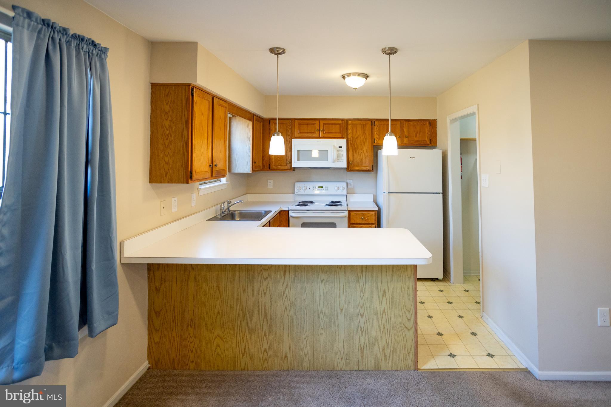 322 Kent Lane Perkasie, PA 18944 - Photo 12 of 36 a room with kitchen island a sink a stove and a refrigerator