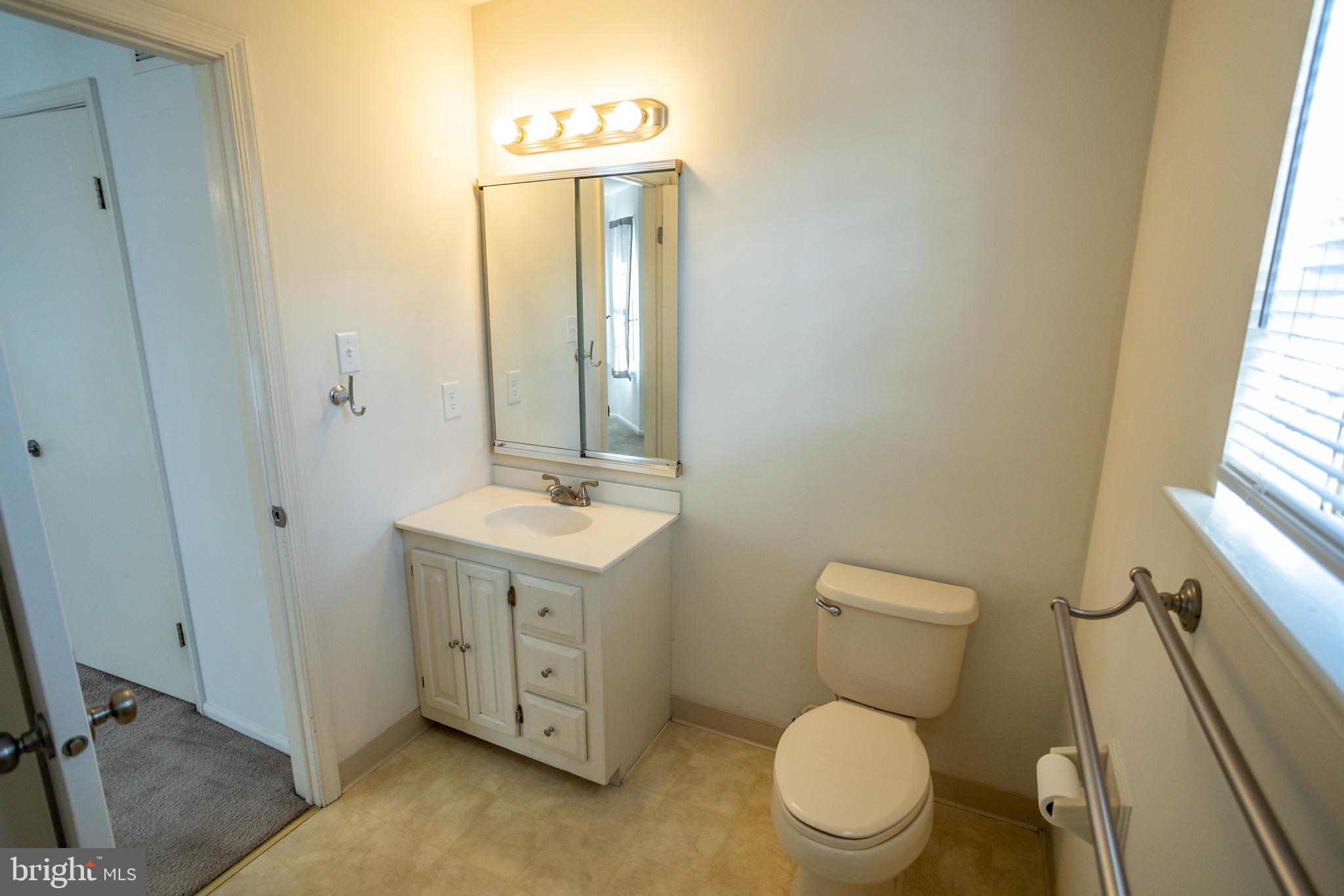 322 Kent Lane Perkasie, PA 18944 - Photo 21 of 36 a bathroom with a toilet a sink a vanity and mirror