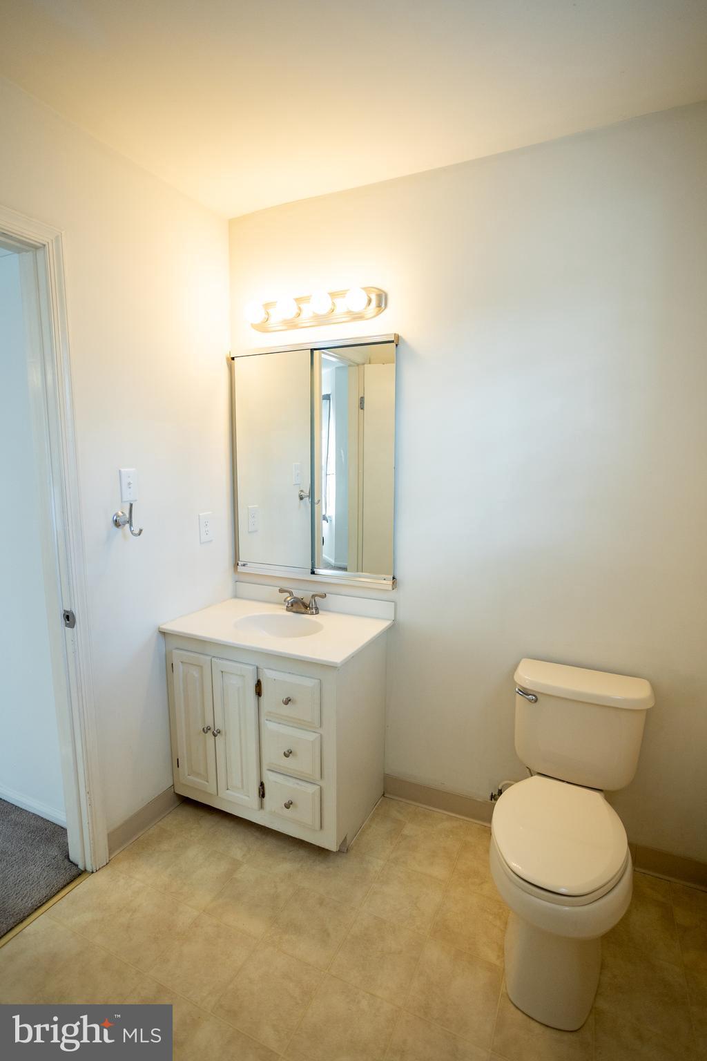 322 Kent Lane Perkasie, PA 18944 - Photo 22 of 36 a bathroom with a granite countertop toilet a sink and mirror