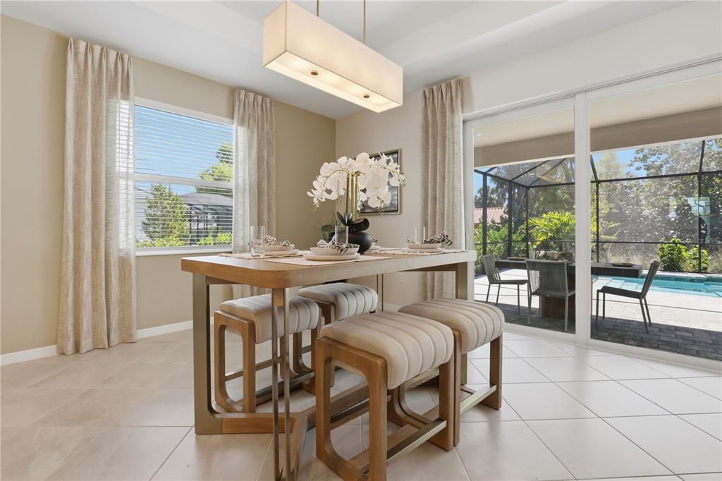 7153 Inlet Isles Lakewood Ranch, FL 34202 - Photo 15 of 26 a dining room with furniture and a large window