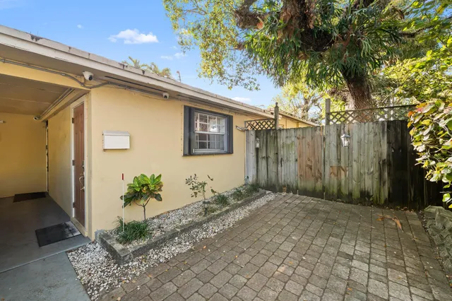 a backyard of a house with a tree
