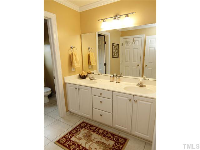 7221 Spring Meadow Lane Raleigh, NC 27606 - Photo 18 of 25 Upstairs bath with dual sinks and also new tile flooring.