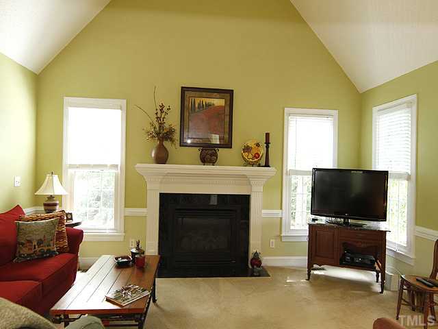 7221 Spring Meadow Lane Raleigh, NC 27606 - Photo 5 of 25 Cozy family room off the kitchen with cathedral ceiling and gas logs.