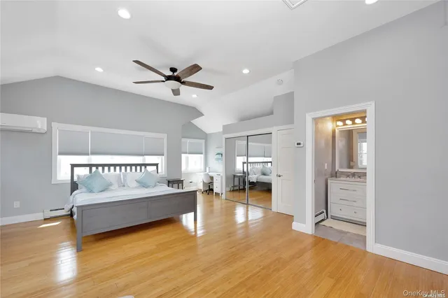 a view of a livingroom with furniture wooden floor and a ceiling fan