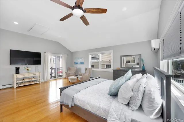 a bedroom with furniture and a flat screen tv