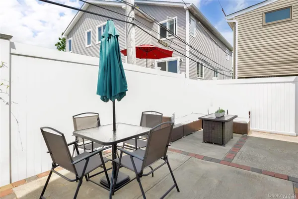 a view of a patio with table and chairs