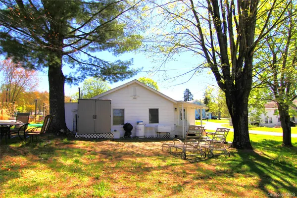 a view of a house with a tree back yard