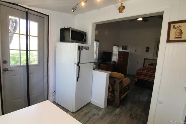 a view of a livingroom with wooden floor and a flat screen tv