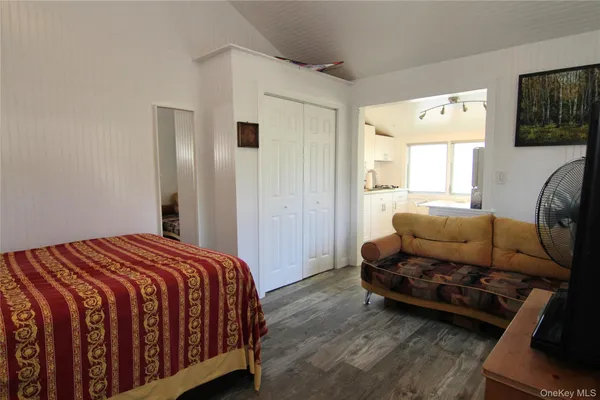 a bedroom with a bed and a couch