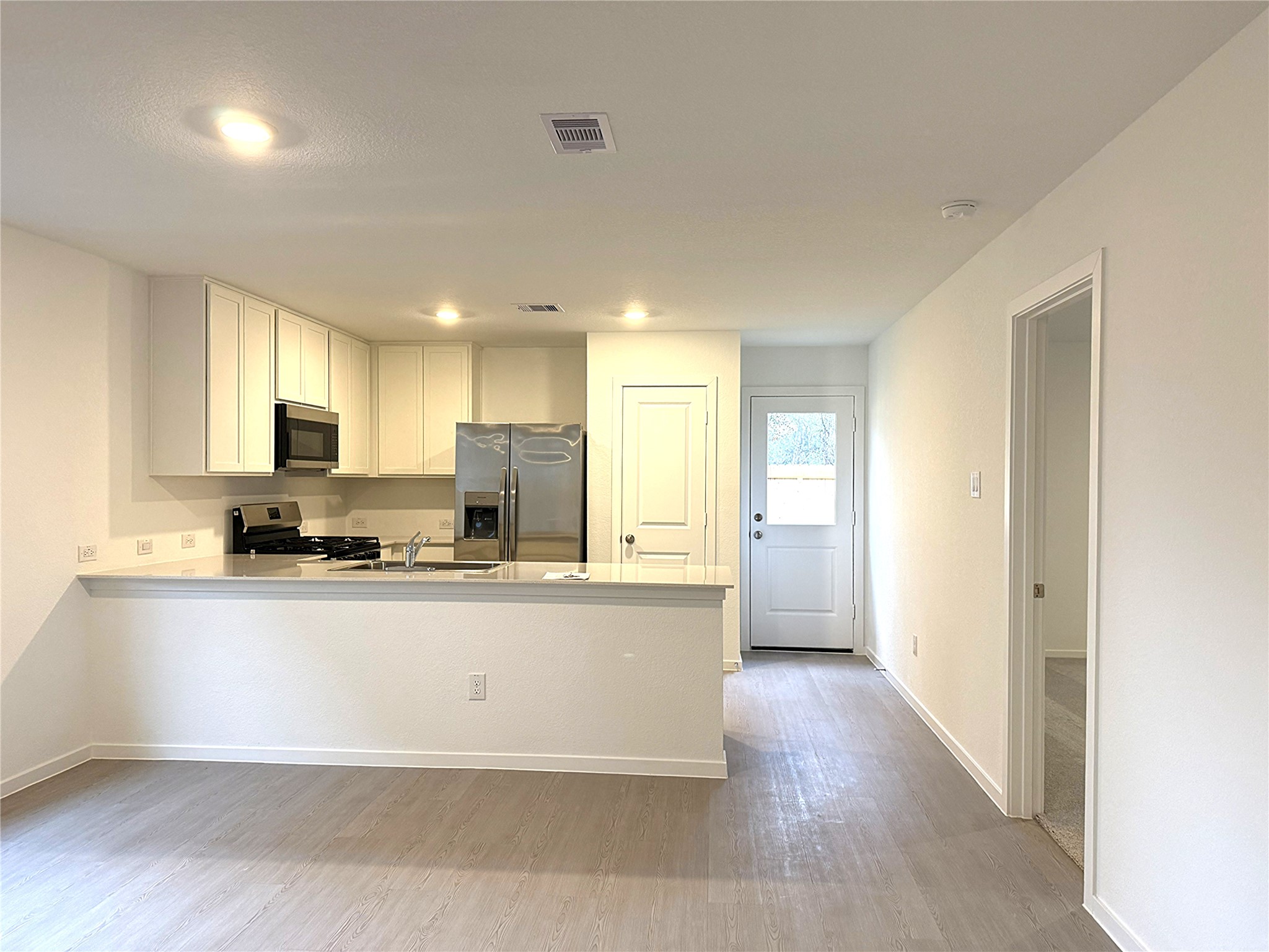 1511 Sunset Ridge Drive Conroe, TX 77306 - Photo 6 of 11 a large kitchen with stainless steel appliances granite countertop a stove a sink and a refrigerator