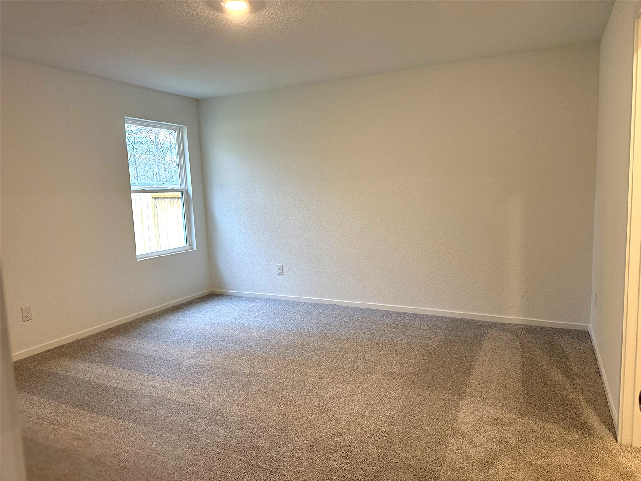 1511 Sunset Ridge Drive Conroe, TX 77306 - Photo 7 of 11 an empty room with windows and closet