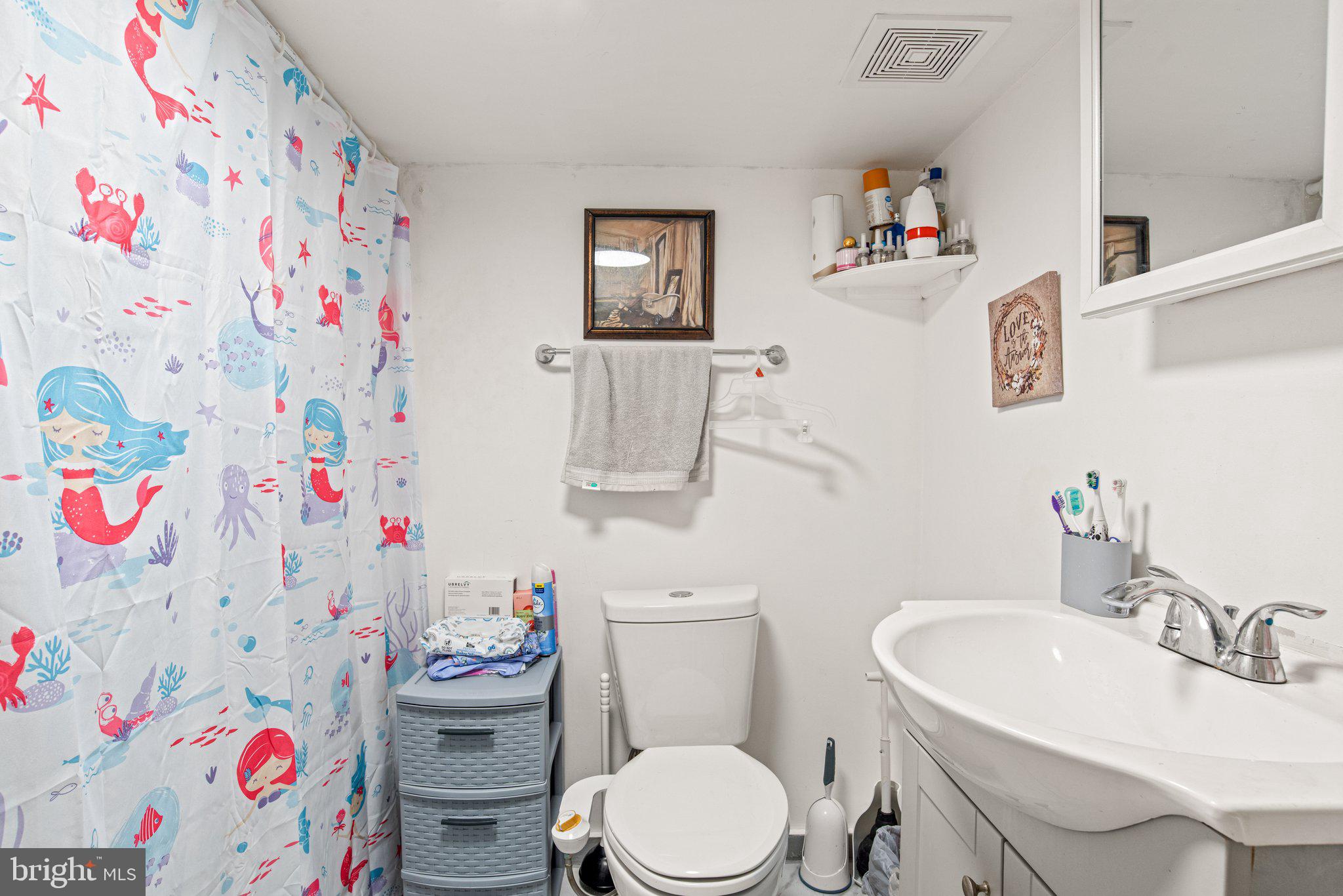 1024 Edison Street York, PA 17403 - Photo 26 of 30 a bathroom with a sink a toilet and a curtain