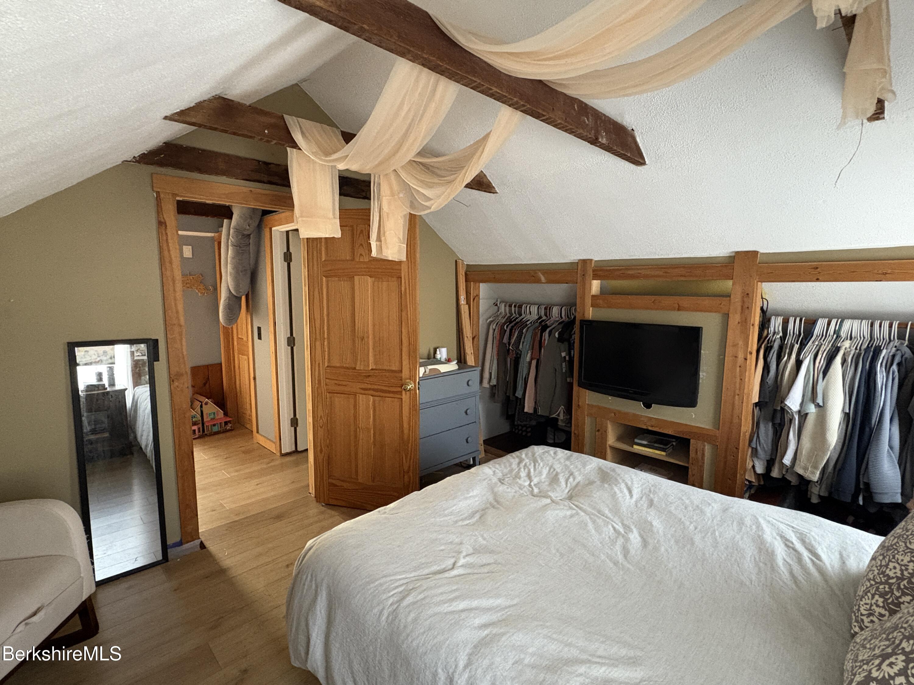 20 Moscow Road West Stockbridge, MA 01266 - Photo 25 of 33 a bedroom with a bed and a flat tv screen on wall