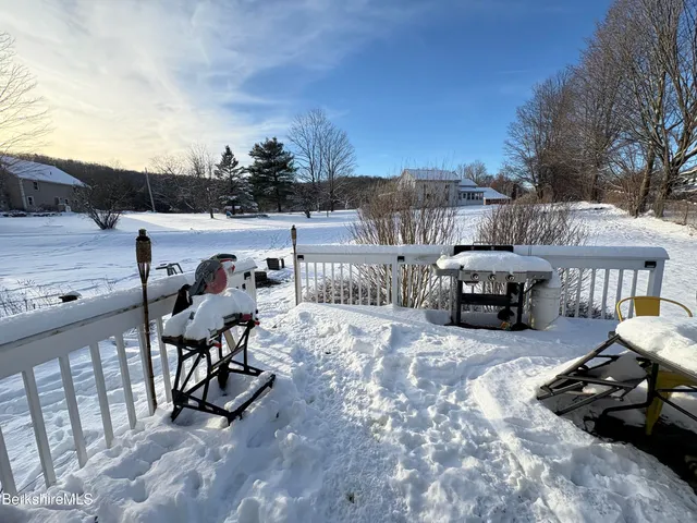 a view of a big house in a big yard with large trees