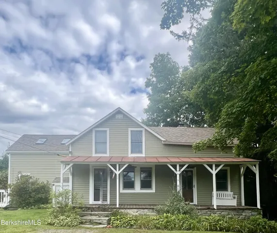 a living room with furniture rug and a window