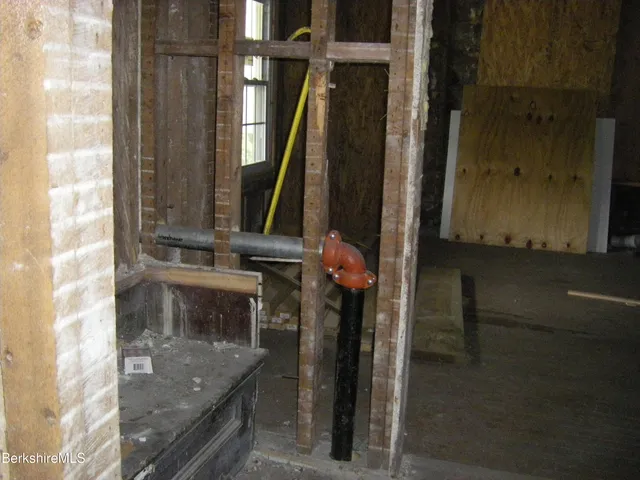 a view of a backyard with couches under an umbrella