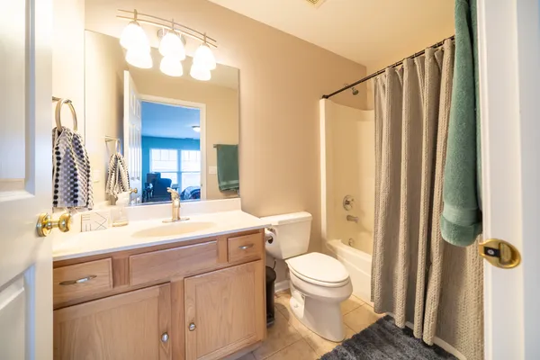 a bathroom with a sink a toilet a mirror and shower