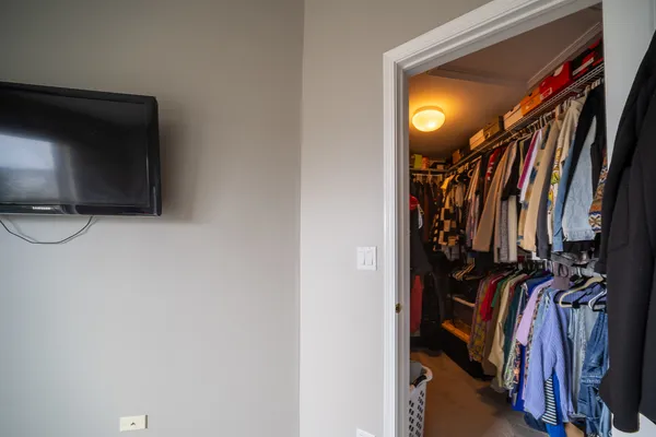 a view of walk in closet with clothes and shoes
