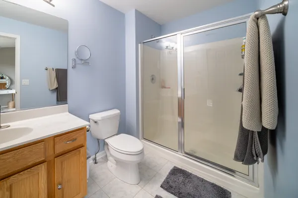 a bathroom with a shower a toilet and sink