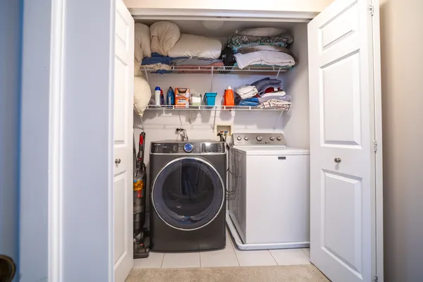 a utility room with a wooden floor washer and dryer