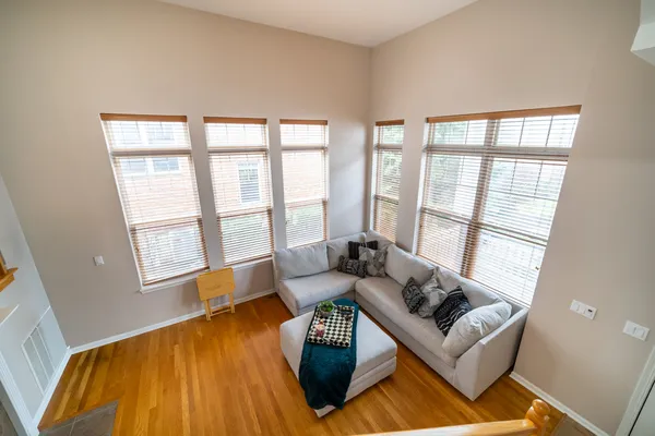 a living room with furniture and a floor to ceiling window
