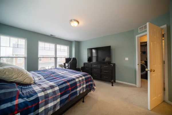 a bedroom with a bed and a television